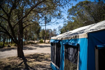 camper trailer tent set up camping in a park in the forest on a hoilday in australia