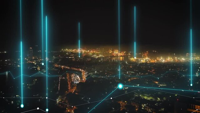Forwards fly above night city. Aerial view of urban borough and logistic terminal in seaport glowing into dark. Colombo, Sri Lanka. Added augmented reality visual effects