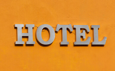 hotel advertisement with metal letters on the exterior facade, hotel concept