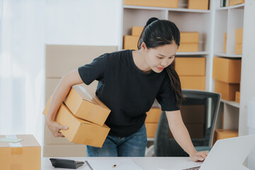 Small online SME business new startup Current online stores Young woman Chia checks orders and prepares packages for delivery to customers.