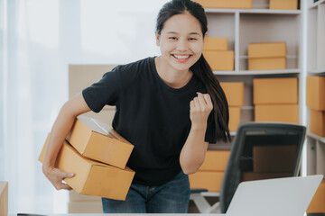 Small online SME business new startup Current online stores Young woman Chia checks orders and prepares packages for delivery to customers.