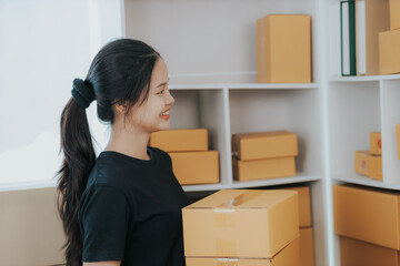 Small online SME business new startup Current online stores Young woman Chia checks orders and prepares packages for delivery to customers.