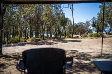 Cooking on a gas cooker at a campsite in the Forrest. Cooking outside on a blue camper trailer. Having fun in a tent in the bush in a national park in Sydney, nsw, Australia.