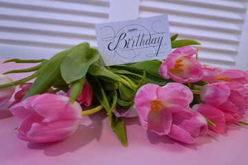 Fototapeta premium postcard , Internet banner with a birthday greeting, with the inscription - happy birthday, a bouquet of flowers with a note of congratulations