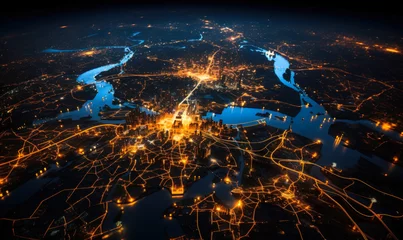 Tuinposter Aerial view of a city at night showcasing the intricate network of illuminated streets and highways, embodying the pulsating life of urban infrastructure © Bartek