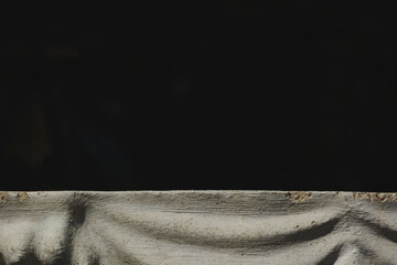 Close up shot of stucco art on black background.