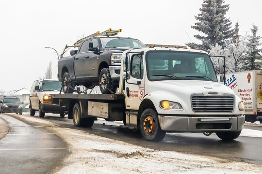 Calgary, Alberta, Canada. Feb 8, 2024. A Truck trailer towing a truck during winter.