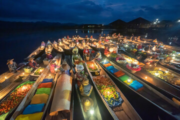 Obraz premium Damnoen Saduak Floating Market or Amphawa. Local people sell fruits, traditional food on boats in canal, Ratchaburi District, Thailand. Famous Asian tourist attraction destination. Festival in Asia.