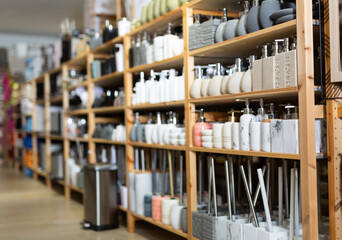 Soap dispensers, toilet brushes and toothbrush holders for sale in home furnishings store. Showcase...