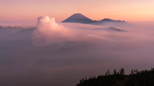 4k Timelapse Movie Sunrise Scene of Moving Cloud, Fog and Smoke of Eruption Cover Volcano Mts. Bromo, Semeru, Batok and Widodaren, Tengger Caldera, Indonesia