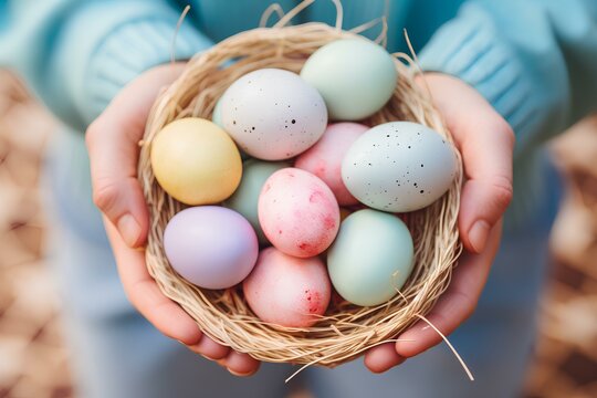 Close up of soft pastel colors painted Easter eggs in a basket holding by kid