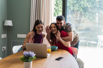 Group of friends making video call through the laptop at home