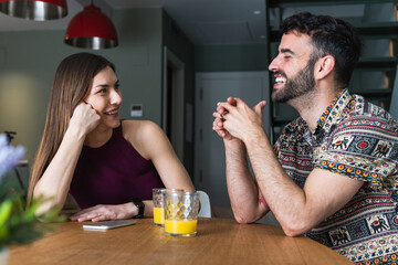 Couple talking during breakfast at home