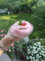 pink dessert with blended berries, strawberries, raspberries, mint in a glass bowl, dessert against...