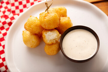 Fried breaded cheese balls, easy and delicious homemade snack recipe. Served with dipping sauce.