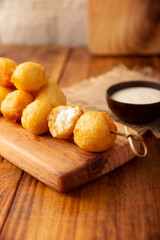 Fried breaded cheese balls, easy and delicious homemade snack recipe. Served with dipping sauce.