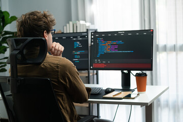 IT developer working online software development on pc monitors at modern home office on coding application screens, creating updated latest program firmware information version concept. Gusher. - obrazy, fototapety, plakaty