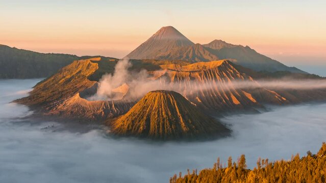 4k Timelapse Movie Sunrise Scene of Moving Cloud, Fog and Smoke of Eruption Cover Volcano Mts. Bromo, Semeru, Batok and Widodaren, Tengger Caldera, Indonesia
