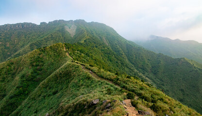 Fototapeta na wymiar Small trails on the mountain ridge leads to the high peak with heart-shape rocks in Jinguashi, New Taipei City, Taiwan.