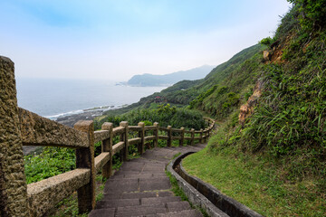 Fototapeta na wymiar Beautiful rock trails meandered in the mountain, with ocean nearby, in New Taipei City, Taiwan.