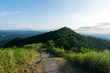 Naklejka premium Small mountain trail go through the mountain at a distance, in New Taipei City, Taiwan.