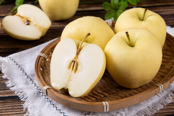fresh yellow apples on wooden table
