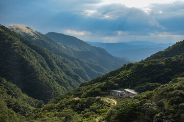 Naklejka premium Little adorable old house sitting in the mountainside, hiding between mountains, in New Taipei City, Taiwan.