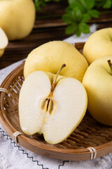 Naklejka na ściany i meble fresh yellow apples on wooden table