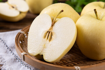 fresh yellow apples on wooden table