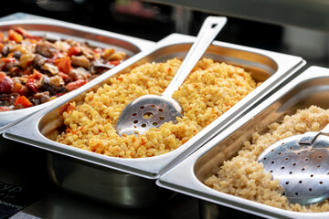 Metal trays with fresh food in a canteen