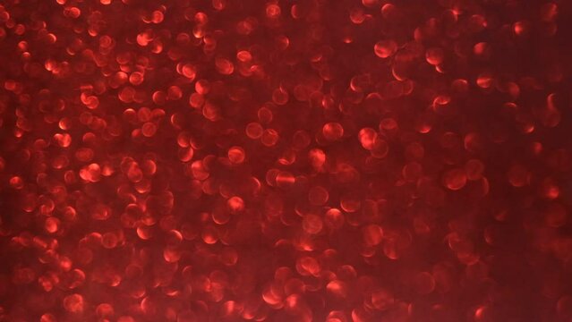 Glittering abstract flares bokeh background. Blurry abstract fairy light background with bokeh. Red color