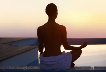 Fotobehang Back, yoga and woman meditate at sunset by swimming pool for healthy body, wellness and zen outdoor on mockup space. Rear view, lotus pose and silhouette of person at twilight to relax, peace or calm © Mapodile M./peopleimages.com