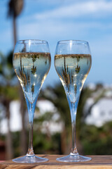 Pouring a glass of champagne on vacation, south of Fuerteventura, Canary islands, blue ocean, mountains