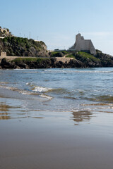 View on sandy beach and sea water in medieval small touristic coastal town Sperlonga and sea shore, Latina, Italy