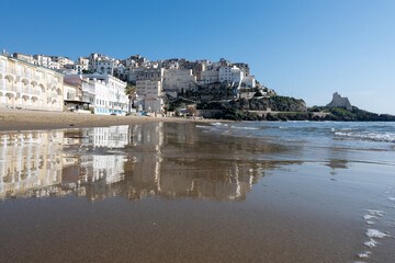 Fototapeta premium View on sandy beach and sea water in medieval small touristic coastal town Sperlonga and sea shore, Latina, Italy