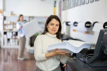 Technician working on plotter and cutter machine in printing centar