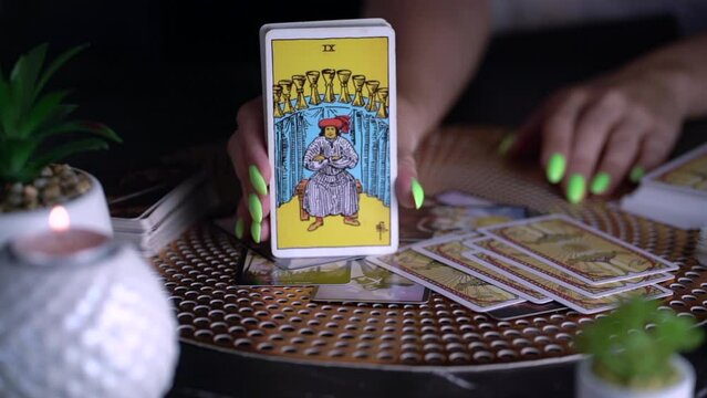 Fortune teller woman showing the card. Slow motion