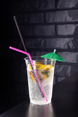 Lemonade with lemon slices in a plastic glass