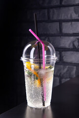 Lemonade with lemon slices in a plastic glass
