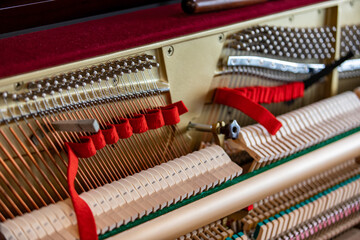 Shallow focus close-up of tools for tuning the internal mechanisms of an upright piano. Gives a...