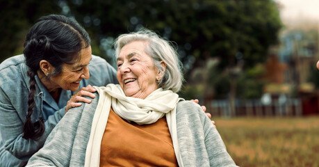 An elderly woman and a younger woman smiling at each other