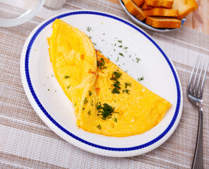 Thin omelette served with bread for breakfast closeup