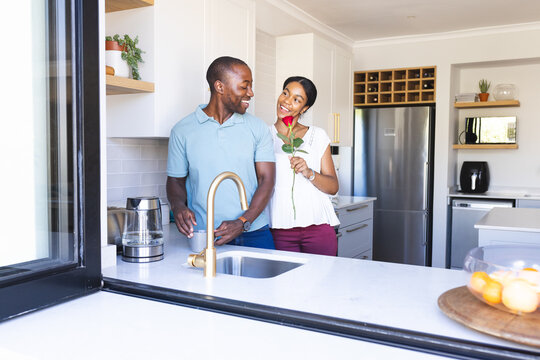 Biracial couple enjoys a playful moment in the kitchen