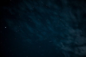 Fototapeta premium Night sky - Universe filled with stars. Stars in the night sky through the clouds