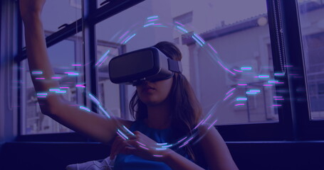 Image of glowing light trails of data transfer over biracial woman in vr headset