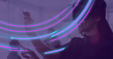 Image of glowing light trails of data transfer over biracial woman using vr headset - Powered by Adobe