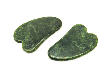 Gua Sha massager from various perspectives isolated on white background. Green jade stone for face and body care. Copy space. Top view.	