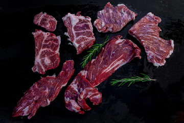 Raw iberian pork meat on black slate