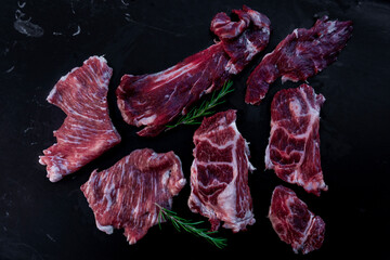 Raw iberian pork meat on black slate