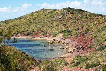 Fototapeta premium Natural landscape of Playa de Cavalleria (Mercadal) in Minorca beach with clear blue sky and rocky seashore- Menorca, Spain
